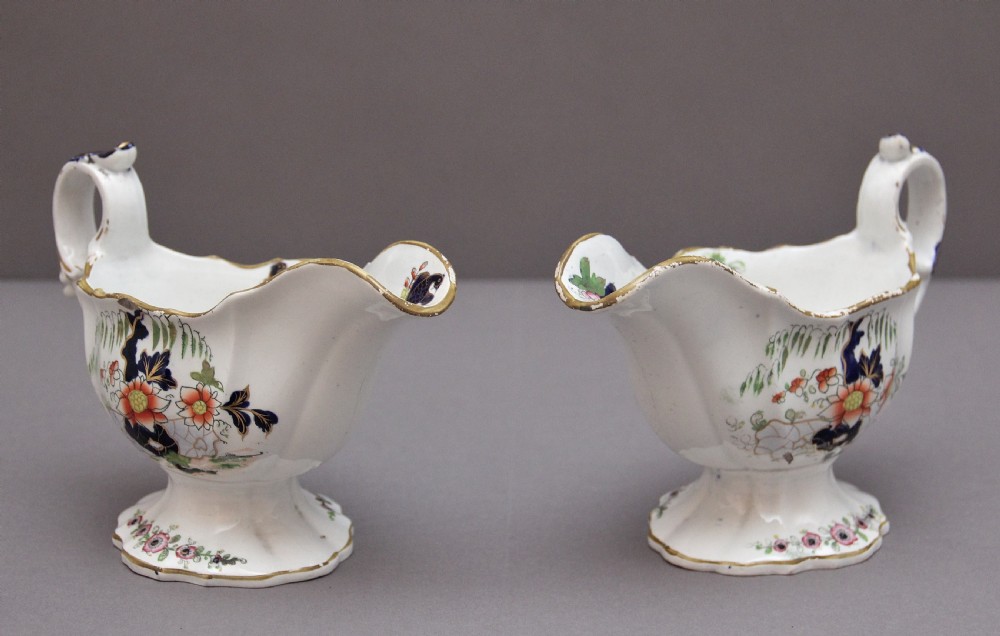 A pair of early nineteenth-century white porcelain sauceboats decorated with hand-painted floral motifs, cobalt blue accents, and gilded scalloped rims. View II