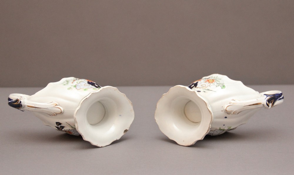 A pair of early nineteenth-century white porcelain sauceboats decorated with hand-painted floral motifs, cobalt blue accents, and gilded scalloped rims. View VIII