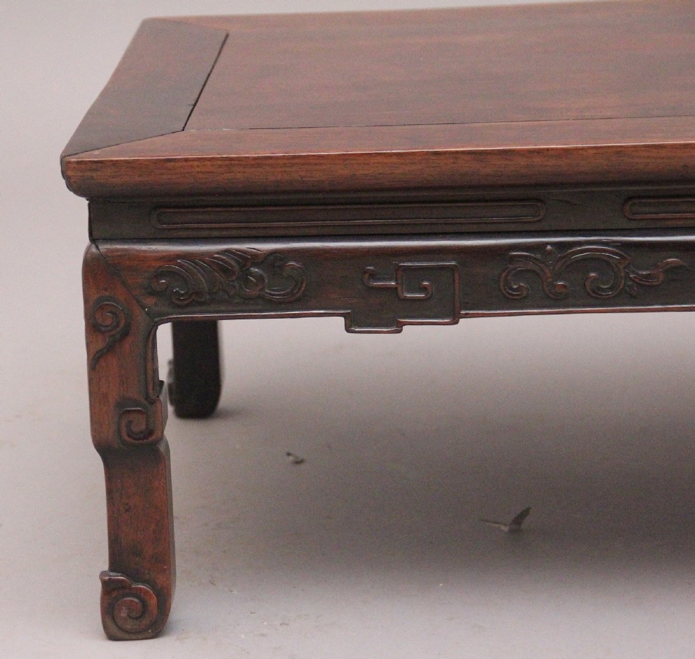 A 19th-century Chinese carved dark wood low table with a floating panel top and stylized scroll feet. View III