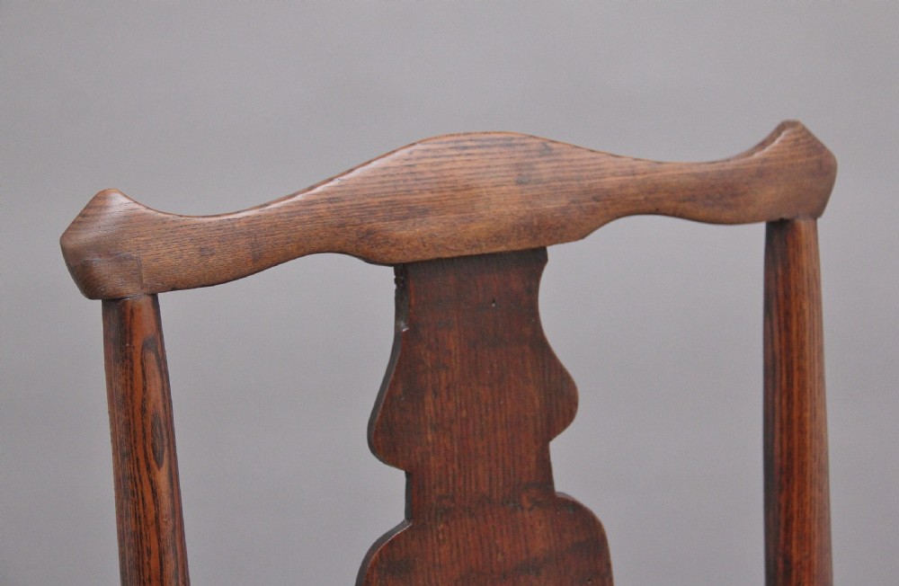 A pair of 18th-century elm side chairs featuring shaped top rails, vasiform back splats, solid wooden seats, and turned front legs with stretchers. View VII