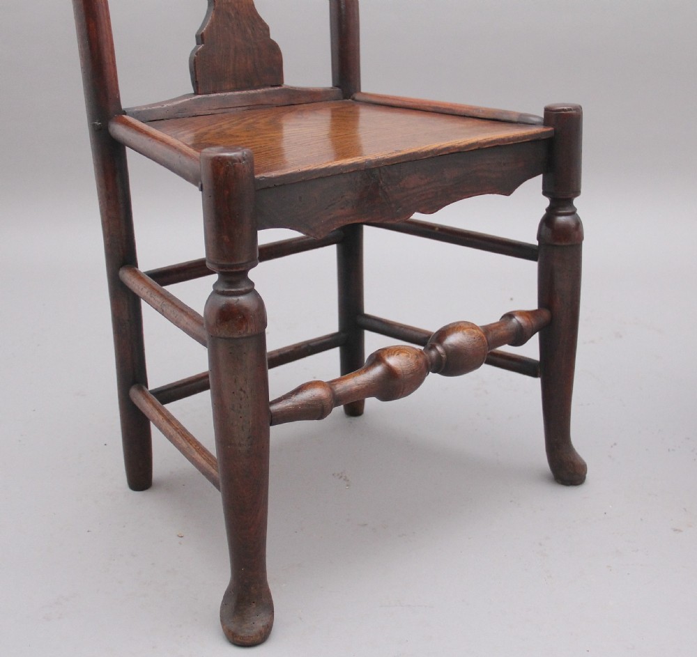 A pair of 18th-century elm side chairs featuring shaped top rails, vasiform back splats, solid wooden seats, and turned front legs with stretchers. View VIII
