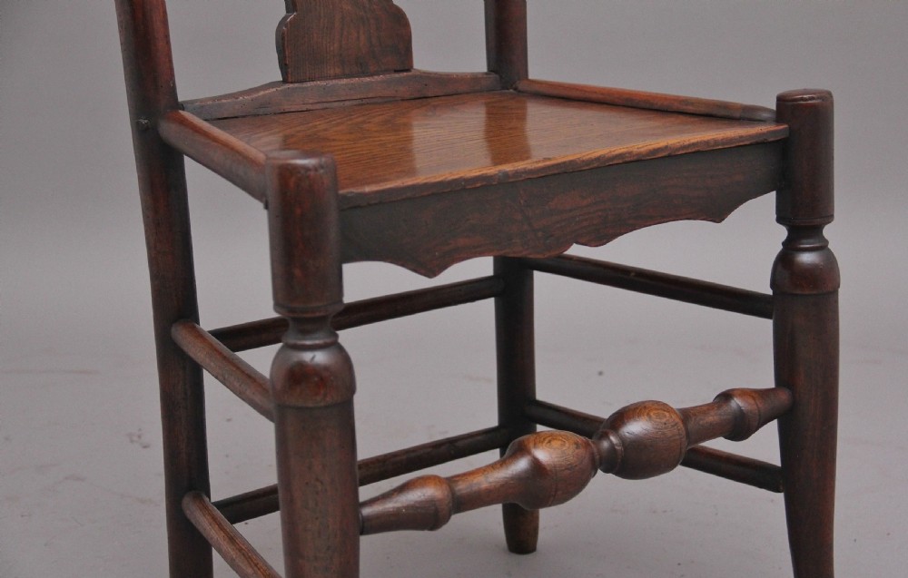 A pair of 18th-century elm side chairs featuring shaped top rails, vasiform back splats, solid wooden seats, and turned front legs with stretchers. View XI