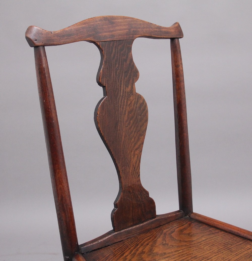 A pair of 18th-century elm side chairs featuring shaped top rails, vasiform back splats, solid wooden seats, and turned front legs with stretchers. View XII