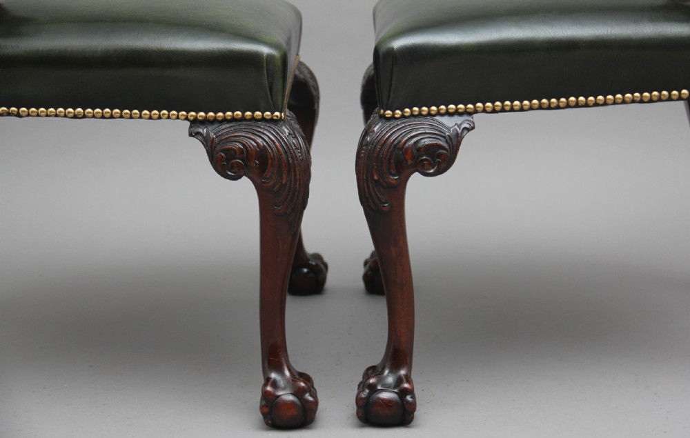 A pair of 19th-century mahogany side chairs featuring pierced carved splats, green leather seats with brass studs, and cabriole legs with ball-and-claw feet. View VII