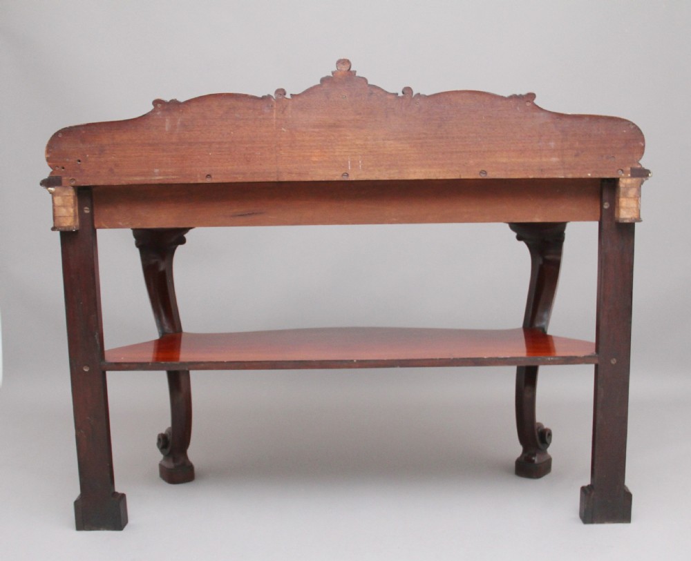 A 19th-century mahogany serving table featuring a carved back gallery, curved cabriole legs, and a lower tier shelf. View IV
