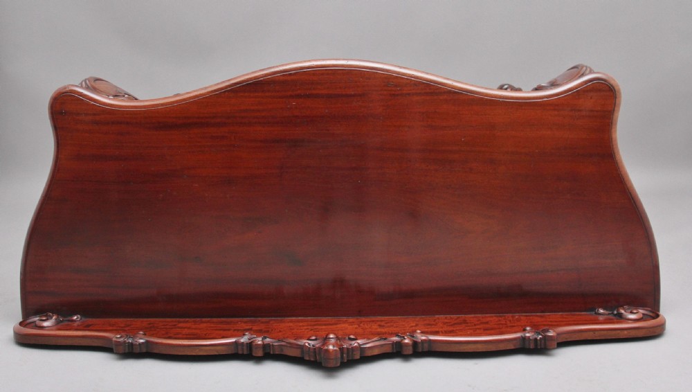 A 19th-century mahogany serving table featuring a carved back gallery, curved cabriole legs, and a lower tier shelf. View VI