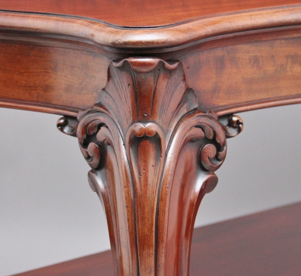 A 19th-century mahogany serving table featuring a carved back gallery, curved cabriole legs, and a lower tier shelf. View VIII