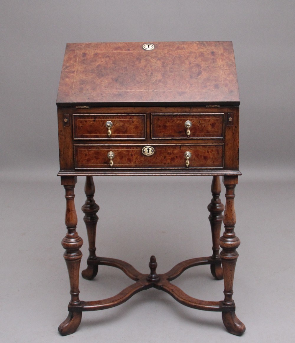 An early 20th-century walnut writing bureau on stand with a sloped fall front, lower drawers, and turned legs with a shaped cross-stretcher. View III