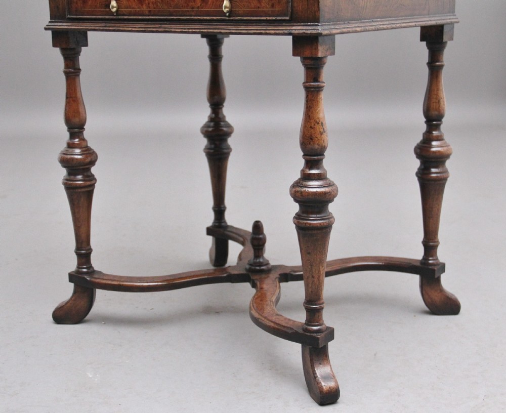 An early 20th-century walnut writing bureau on stand with a sloped fall front, lower drawers, and turned legs with a shaped cross-stretcher. View XII