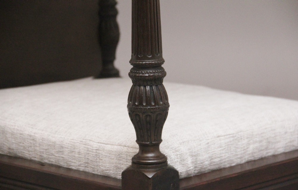 A nineteenth-century mahogany four-poster dog bed featuring carved reeded posts, a moulded canopy frame, and a neutral fabric cushion. View VIII