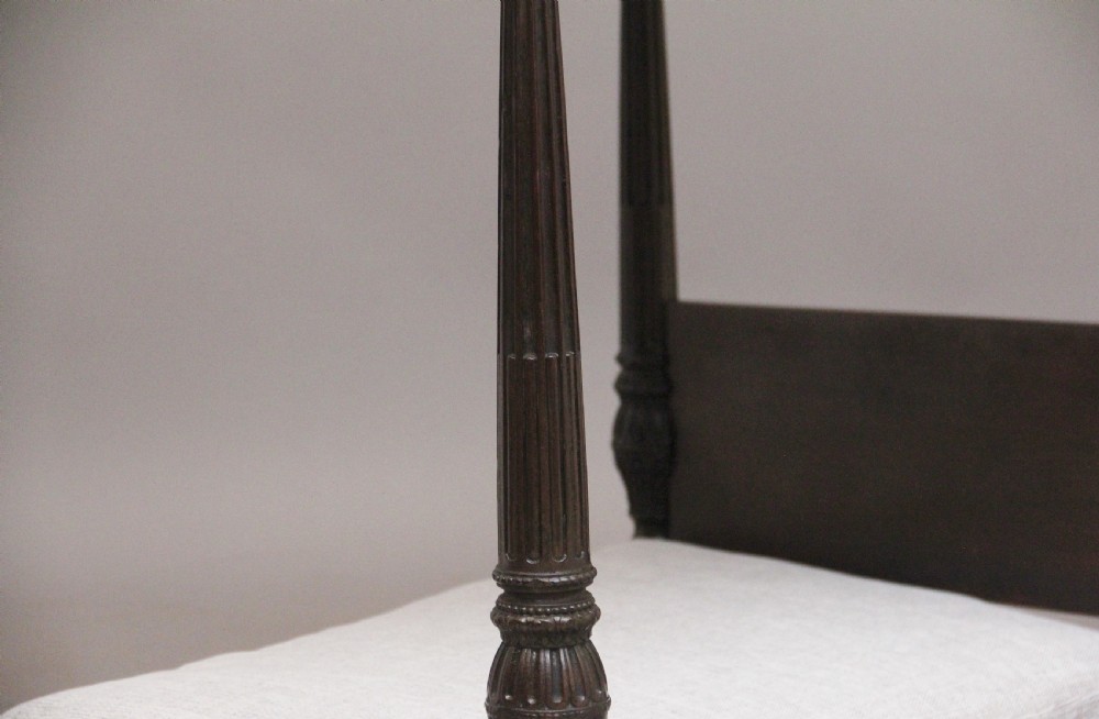 A nineteenth-century mahogany four-poster dog bed featuring carved reeded posts, a moulded canopy frame, and a neutral fabric cushion. View XII