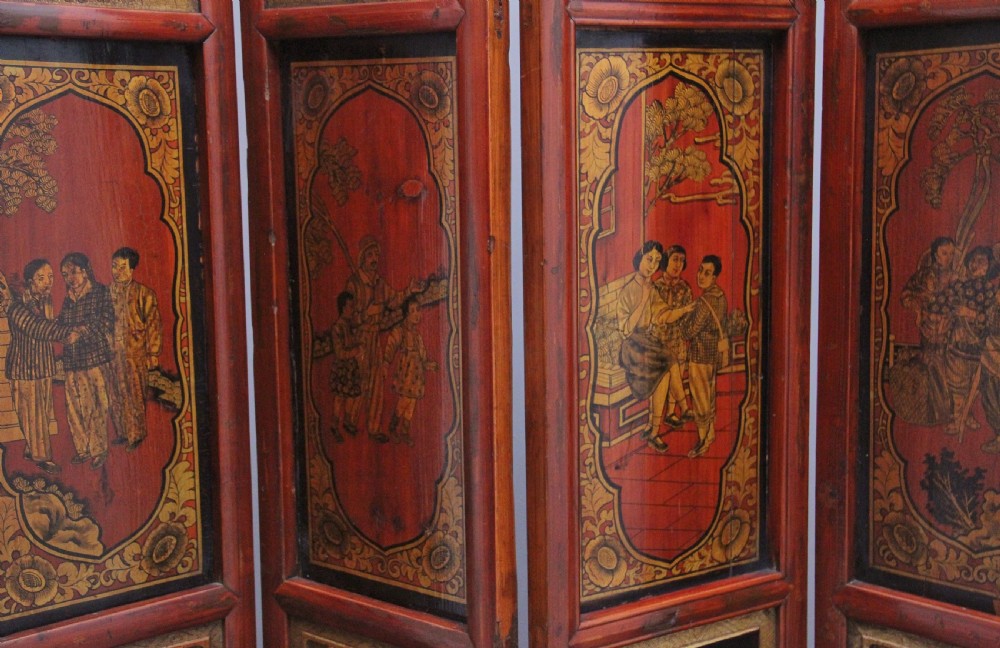 An early 20th-century seven-panel Chinese folding screen featuring crimson and black lacquered sections decorated with hand-painted figures and gilded floral borders. View VII
