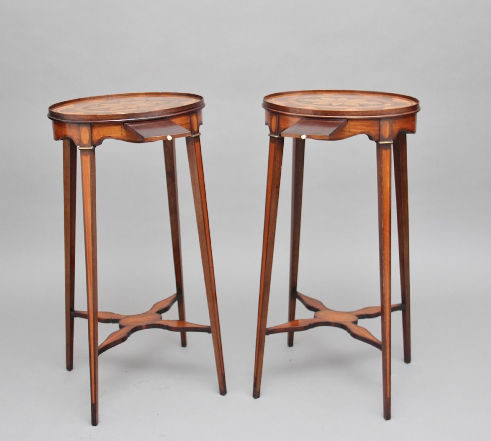 A pair of tall, oval-topped mahogany urn stands featuring central floral marquetry inlays, pull-out slides, square tapered legs, and curved X-form stretchers. View II