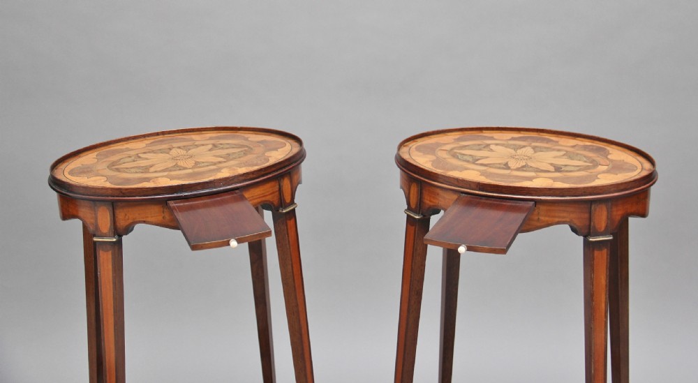 A pair of tall, oval-topped mahogany urn stands featuring central floral marquetry inlays, pull-out slides, square tapered legs, and curved X-form stretchers. View IV