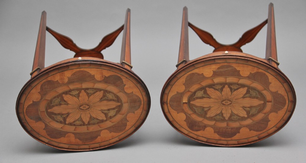 A pair of tall, oval-topped mahogany urn stands featuring central floral marquetry inlays, pull-out slides, square tapered legs, and curved X-form stretchers. View V