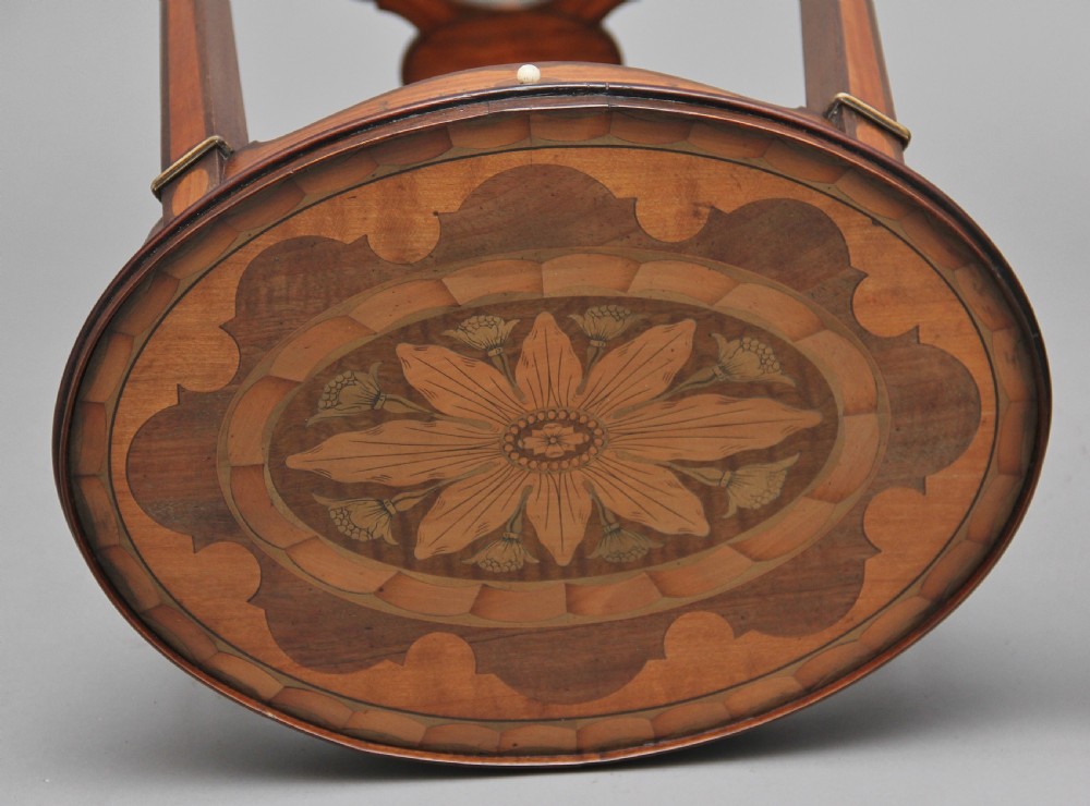A pair of tall, oval-topped mahogany urn stands featuring central floral marquetry inlays, pull-out slides, square tapered legs, and curved X-form stretchers. View VI