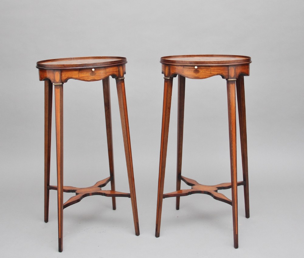 A pair of tall, oval-topped mahogany urn stands featuring central floral marquetry inlays, pull-out slides, square tapered legs, and curved X-form stretchers. View VII
