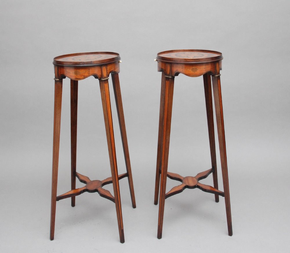 A pair of tall, oval-topped mahogany urn stands featuring central floral marquetry inlays, pull-out slides, square tapered legs, and curved X-form stretchers. View VIII