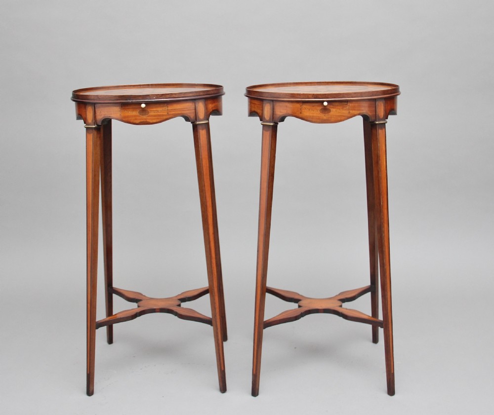 A pair of tall, oval-topped mahogany urn stands featuring central floral marquetry inlays, pull-out slides, square tapered legs, and curved X-form stretchers. View IX