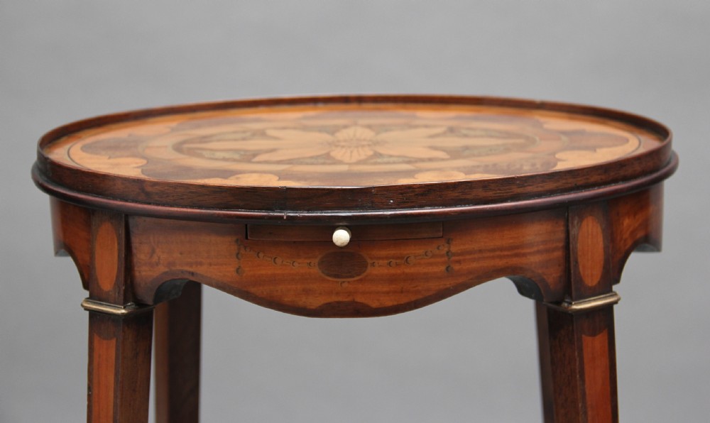 A pair of tall, oval-topped mahogany urn stands featuring central floral marquetry inlays, pull-out slides, square tapered legs, and curved X-form stretchers. View XIII