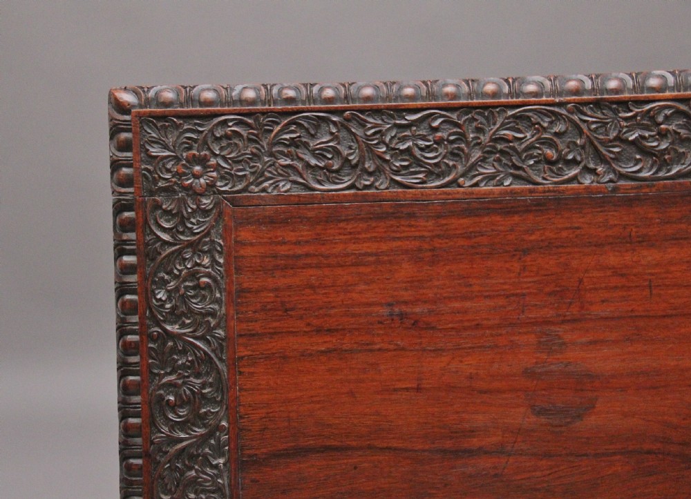 A dark wood double pedestal partners desk featuring intricate relief floral carvings across all drawers, side panels, and top borders. View VIII