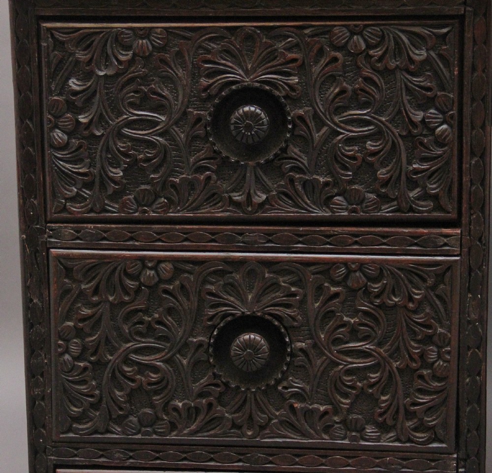 A dark wood double pedestal partners desk featuring intricate relief floral carvings across all drawers, side panels, and top borders. View XI