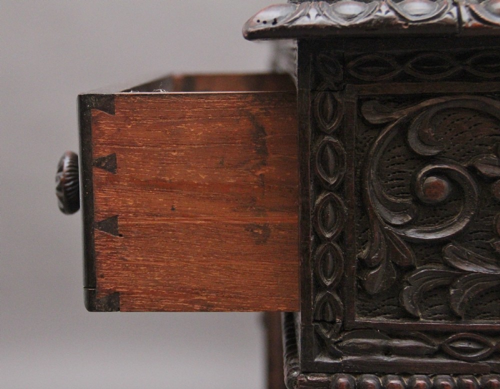 A dark wood double pedestal partners desk featuring intricate relief floral carvings across all drawers, side panels, and top borders. View XIII