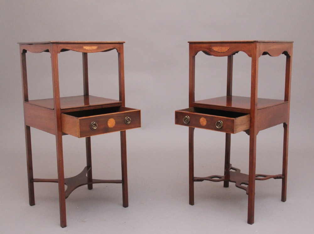 A near pair of tall 19th-century mahogany bedside tables featuring fan marquetry inlay, single drawers with brass ring handles, open upper shelves, and decorative cross-stretchers. View II