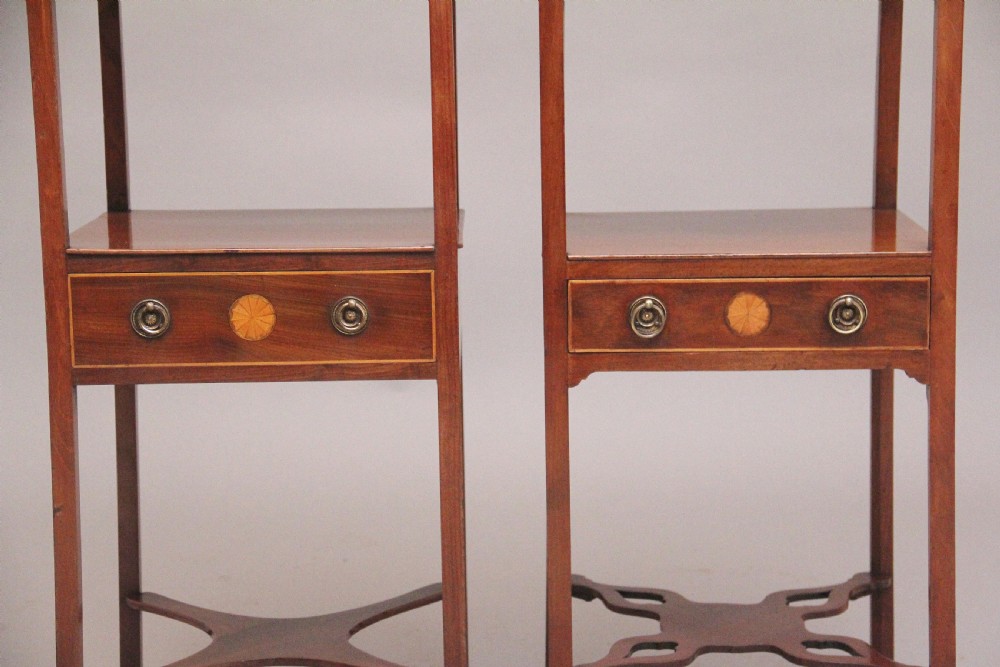 A near pair of tall 19th-century mahogany bedside tables featuring fan marquetry inlay, single drawers with brass ring handles, open upper shelves, and decorative cross-stretchers. View IV