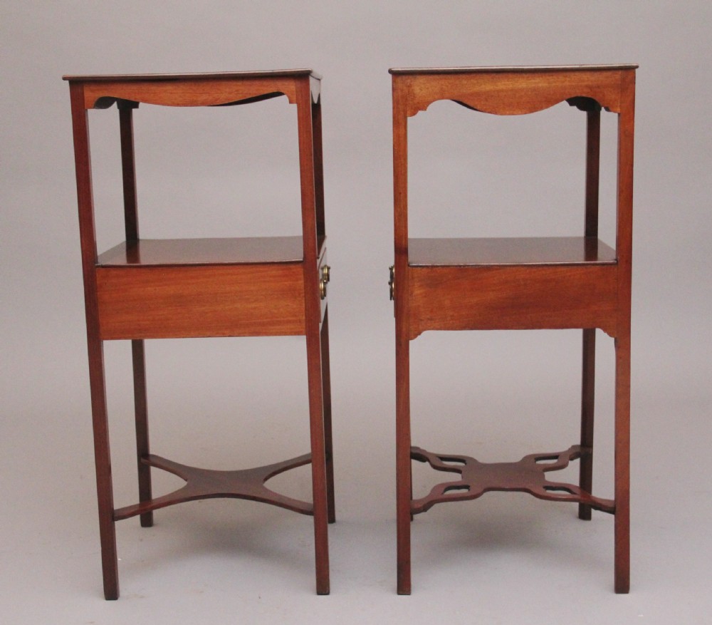 A near pair of tall 19th-century mahogany bedside tables featuring fan marquetry inlay, single drawers with brass ring handles, open upper shelves, and decorative cross-stretchers. View V