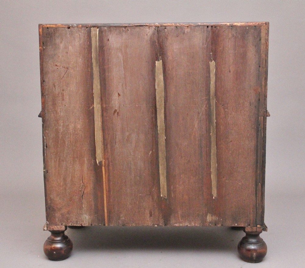 An 18th century walnut writing bureau featuring a sloped fall-front lid, brass drop handles, keyhole escutcheons, and turned ball feet. View XII