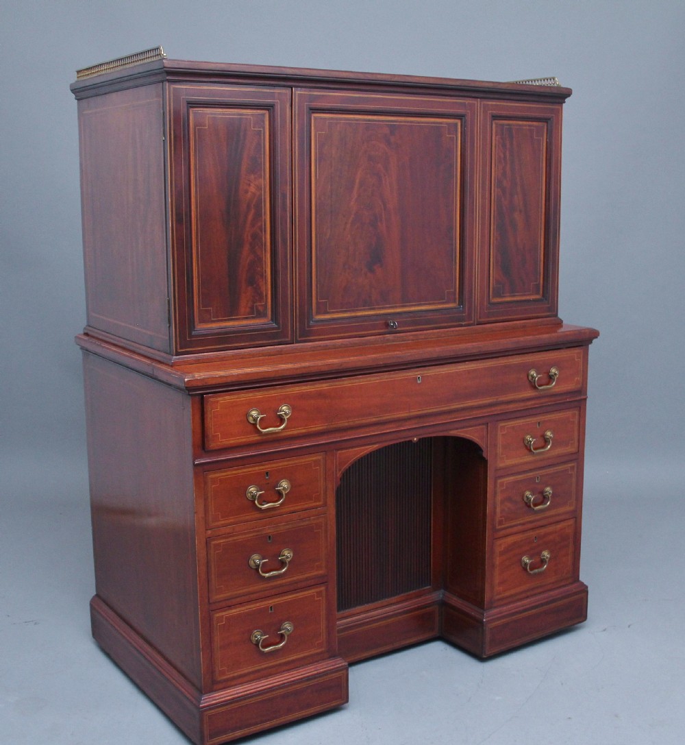 A 19th-century mahogany secretaire desk with open upper cabinet doors, fitted internal pigeonholes, and an extended pull-out writing surface lined in green leather. View II