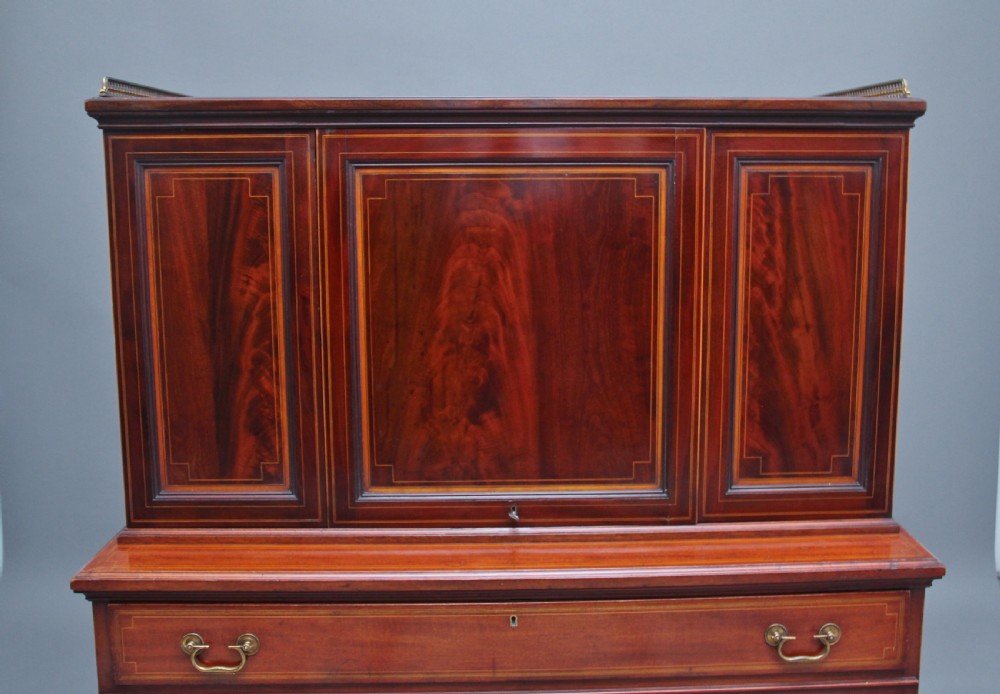 A 19th-century mahogany secretaire desk with open upper cabinet doors, fitted internal pigeonholes, and an extended pull-out writing surface lined in green leather. View VI