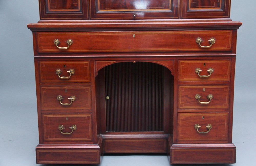 A 19th-century mahogany secretaire desk with open upper cabinet doors, fitted internal pigeonholes, and an extended pull-out writing surface lined in green leather. View VIII