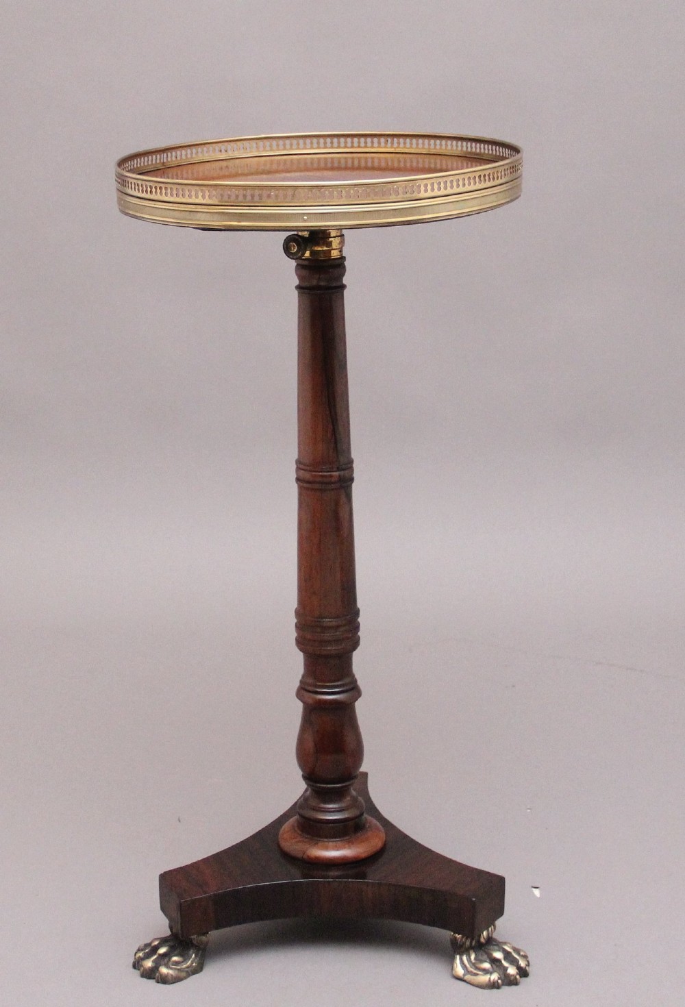 A 19th-century dark rosewood telescopic occasional table with a circular top featuring a brass gallery rim, a turned pedestal column, and a triform base on brass claw feet. View III