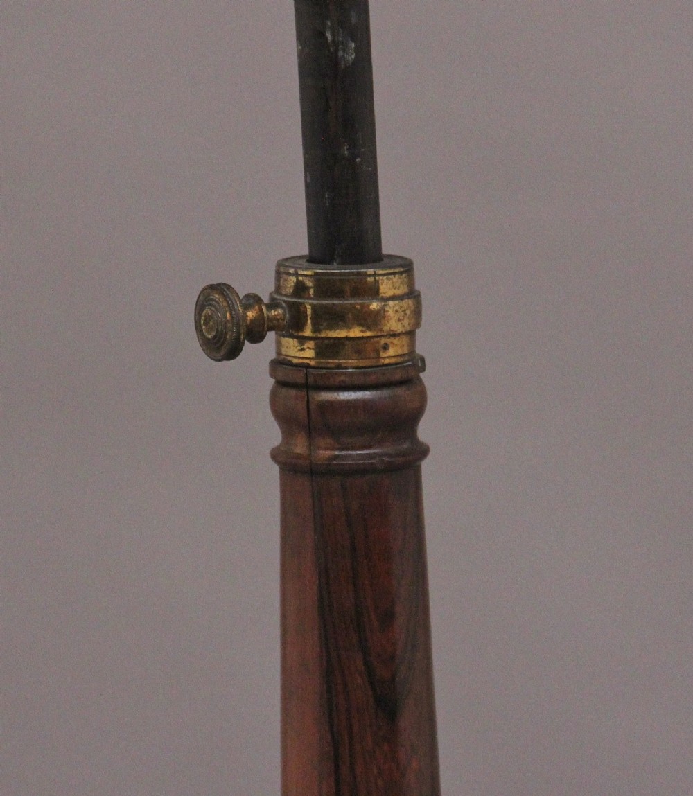A 19th-century dark rosewood telescopic occasional table with a circular top featuring a brass gallery rim, a turned pedestal column, and a triform base on brass claw feet. View IX