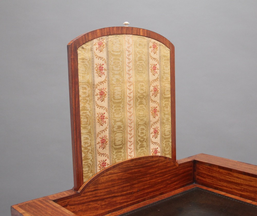 A 19th-century satinwood ladies writing table featuring a stepped side gallery, single frieze drawer, tapered square legs on brass castors, and a lower undertier. View VII