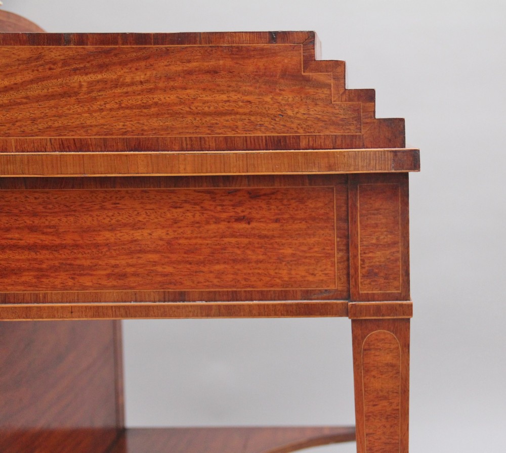 A 19th-century satinwood ladies writing table featuring a stepped side gallery, single frieze drawer, tapered square legs on brass castors, and a lower undertier. View XII