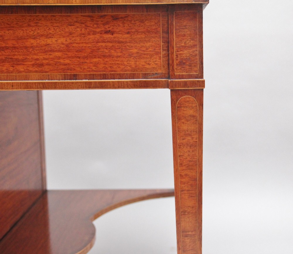 A 19th-century satinwood ladies writing table featuring a stepped side gallery, single frieze drawer, tapered square legs on brass castors, and a lower undertier. View XIII
