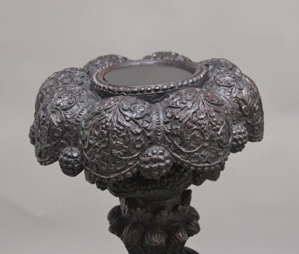A pair of 19th-century Anglo-Indian carved hardwood torcheres featuring detailed cobra and mythical bird motifs topped with lotus platforms. View XV