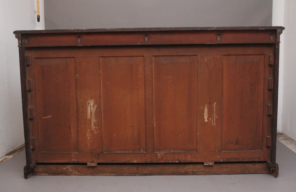 A nineteenth-century low open bookcase crafted from warm walnut wood featuring three sections with adjustable shelving and decorative gilt-bronze ormolu mounts along the borders. View XIV
