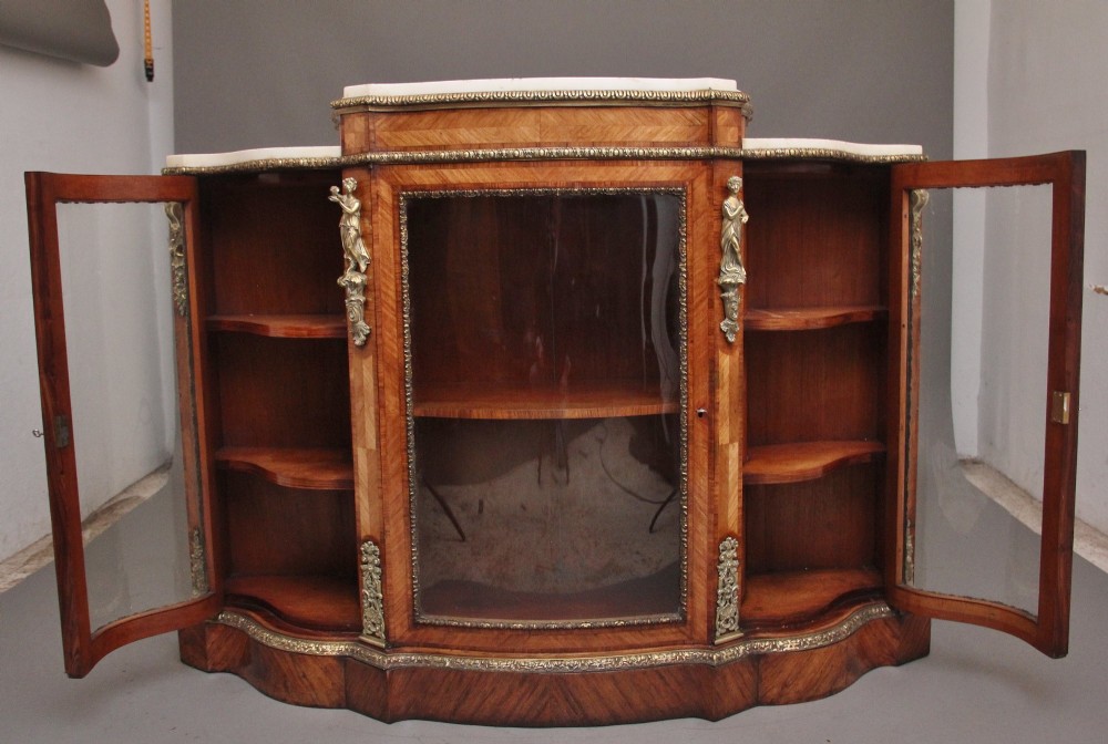 A 19th-century French kingwood credenza featuring a stepped white marble top, three glazed doors, parquetry veneer, and cast gilt-bronze caryatid mounts. View III