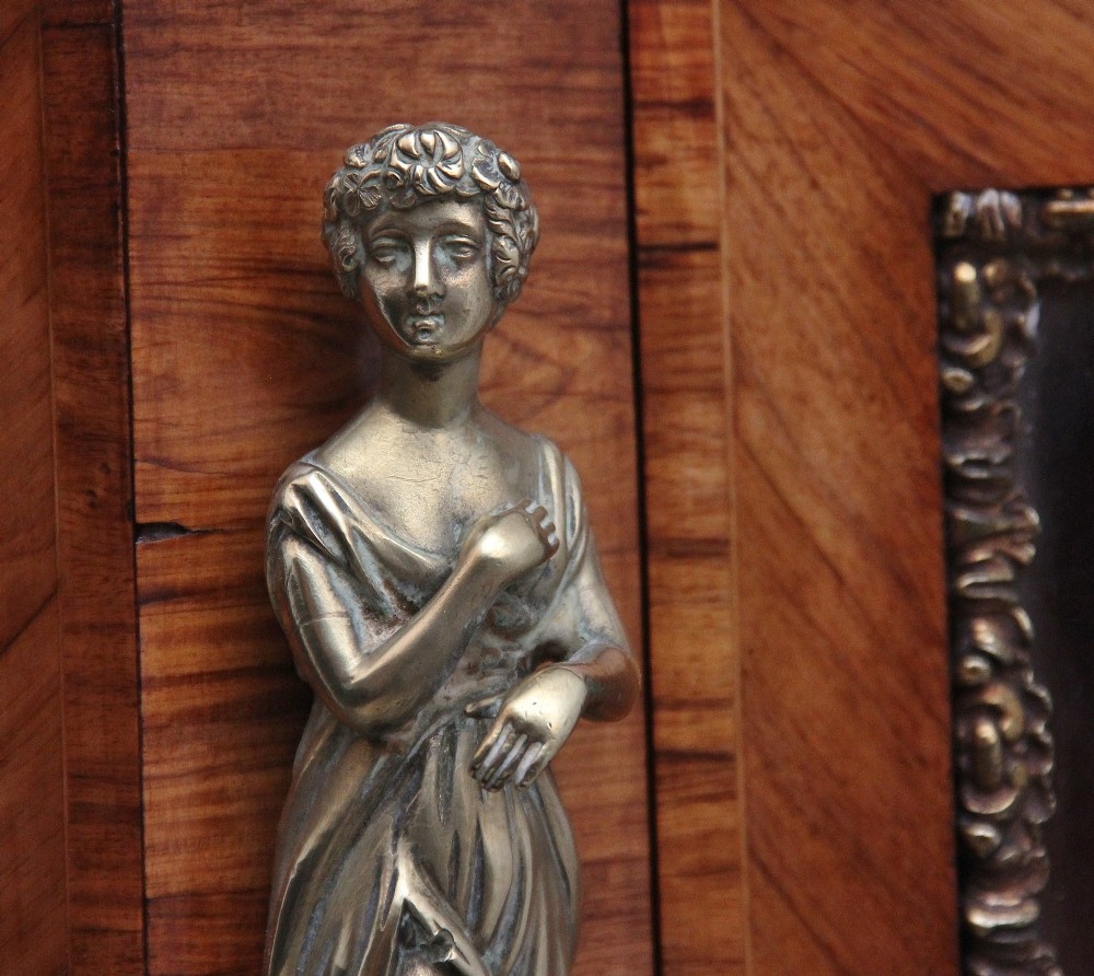 A 19th-century French kingwood credenza featuring a stepped white marble top, three glazed doors, parquetry veneer, and cast gilt-bronze caryatid mounts. View XII