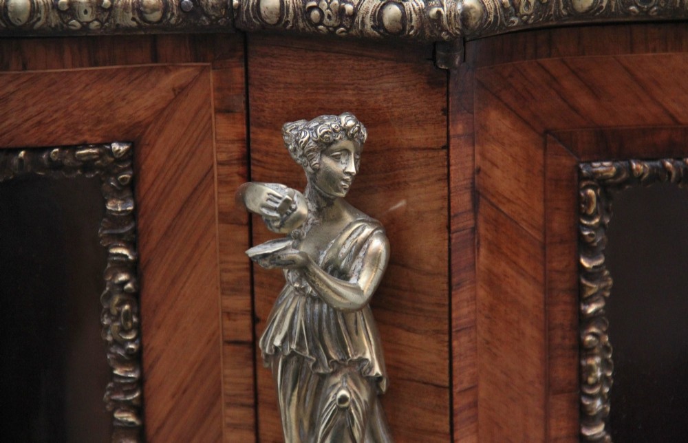 A 19th-century French kingwood credenza featuring a stepped white marble top, three glazed doors, parquetry veneer, and cast gilt-bronze caryatid mounts. View XIII