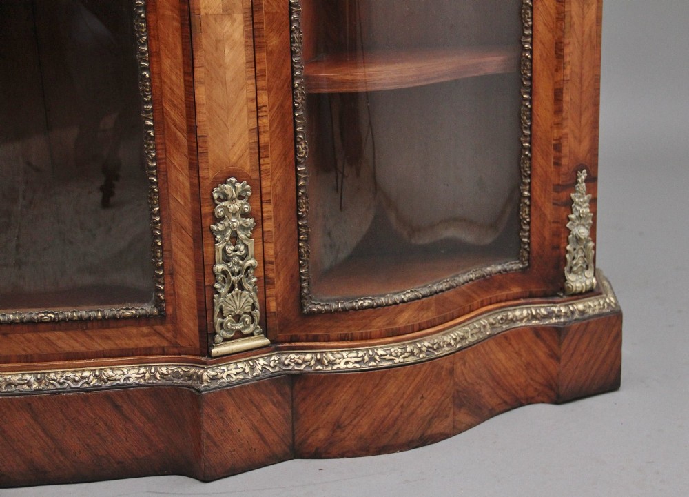 A 19th-century French kingwood credenza featuring a stepped white marble top, three glazed doors, parquetry veneer, and cast gilt-bronze caryatid mounts. View XIV