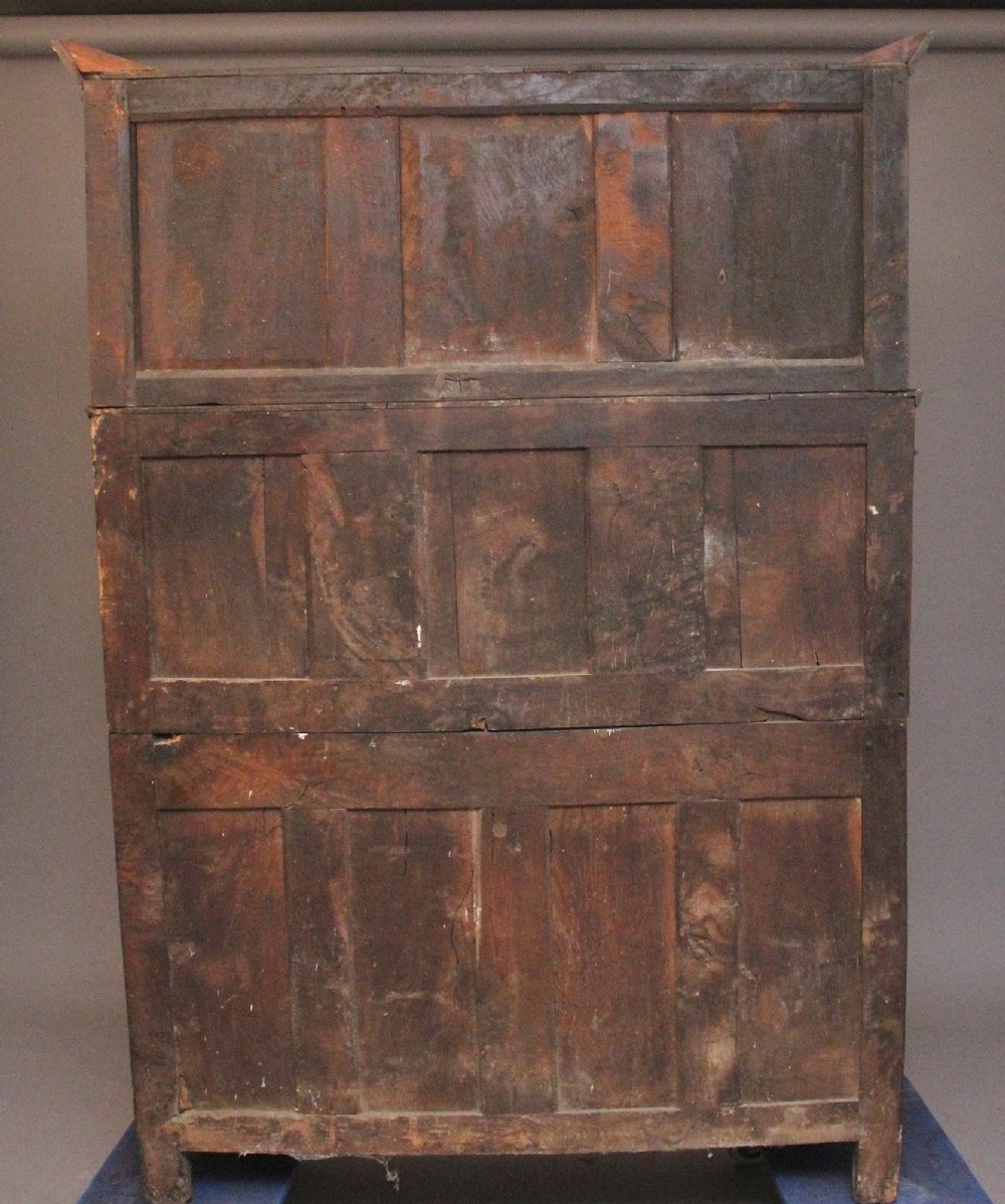 An early eighteenth-century dark Welsh oak tridarn featuring a three-tier design with an open top canopy, middle cupboards with arched panels, and a lower section with drawers and doors. View VII
