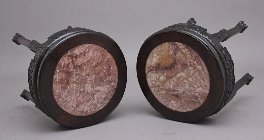 A pair of 19th-century Chinese carved dark hardwood circular occasional tables with inset pink marble tops and carved legs. View III