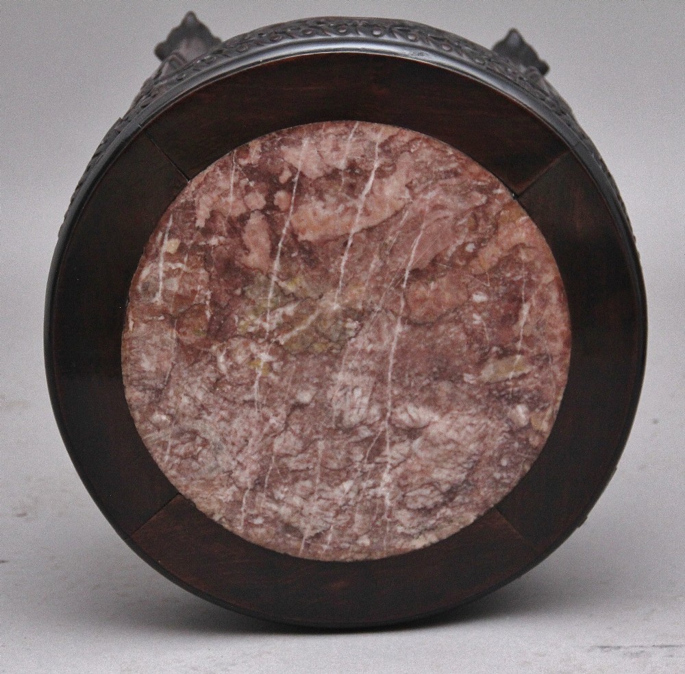 A pair of 19th-century Chinese carved dark hardwood circular occasional tables with inset pink marble tops and carved legs. View IV