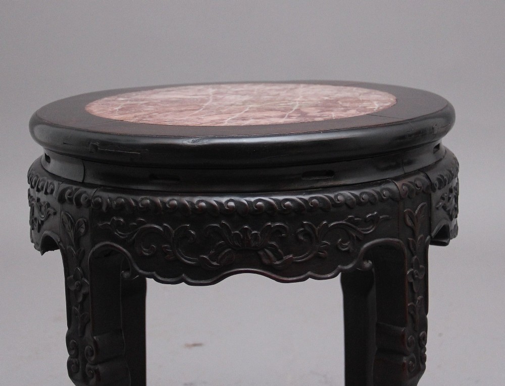 A pair of 19th-century Chinese carved dark hardwood circular occasional tables with inset pink marble tops and carved legs. View VI