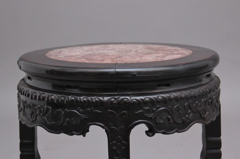 A pair of 19th-century Chinese carved dark hardwood circular occasional tables with inset pink marble tops and carved legs. View VII